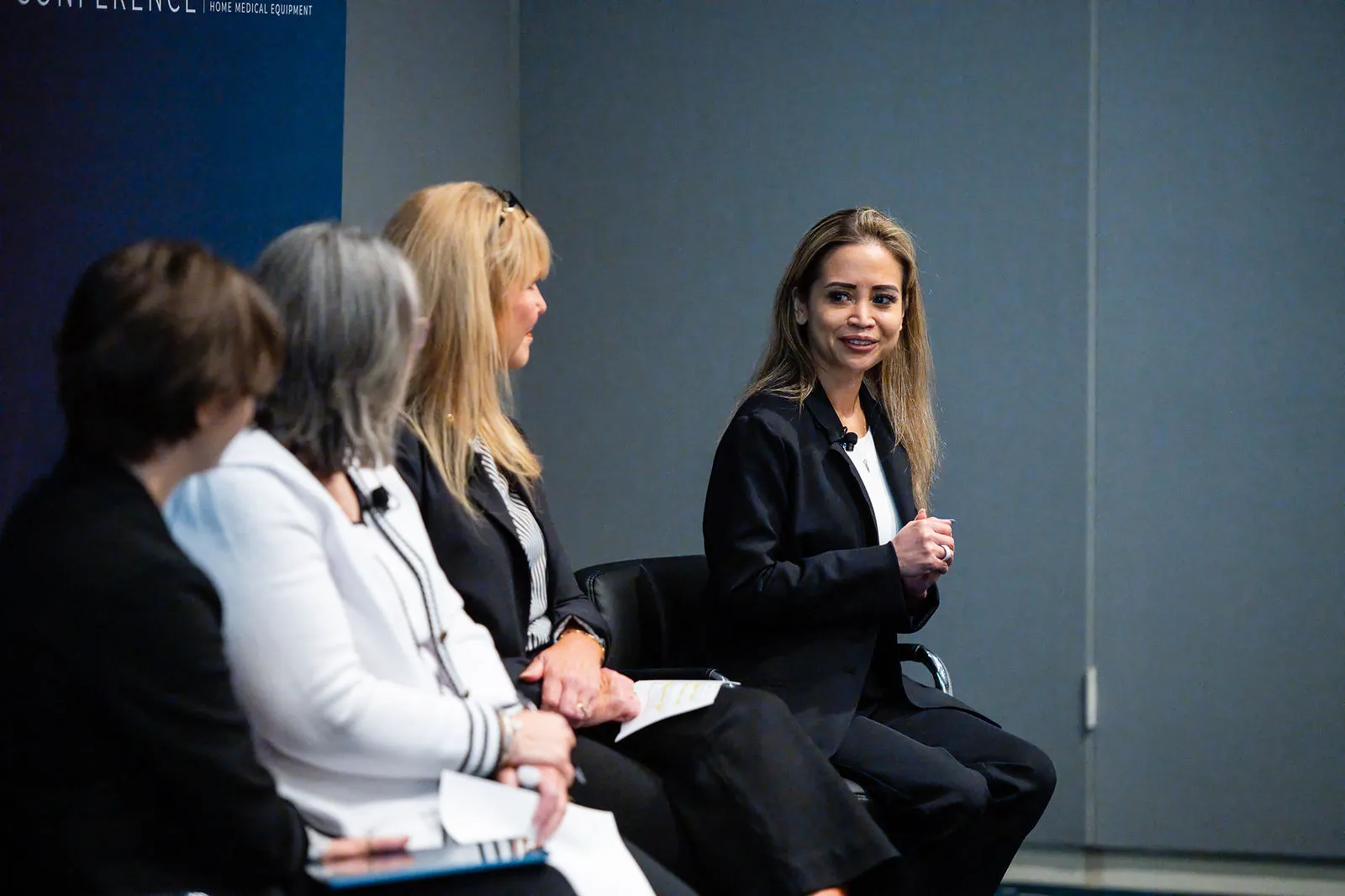 Monica Cutia smiling as she listens on a panel at the Arrowfly FUTURE conference